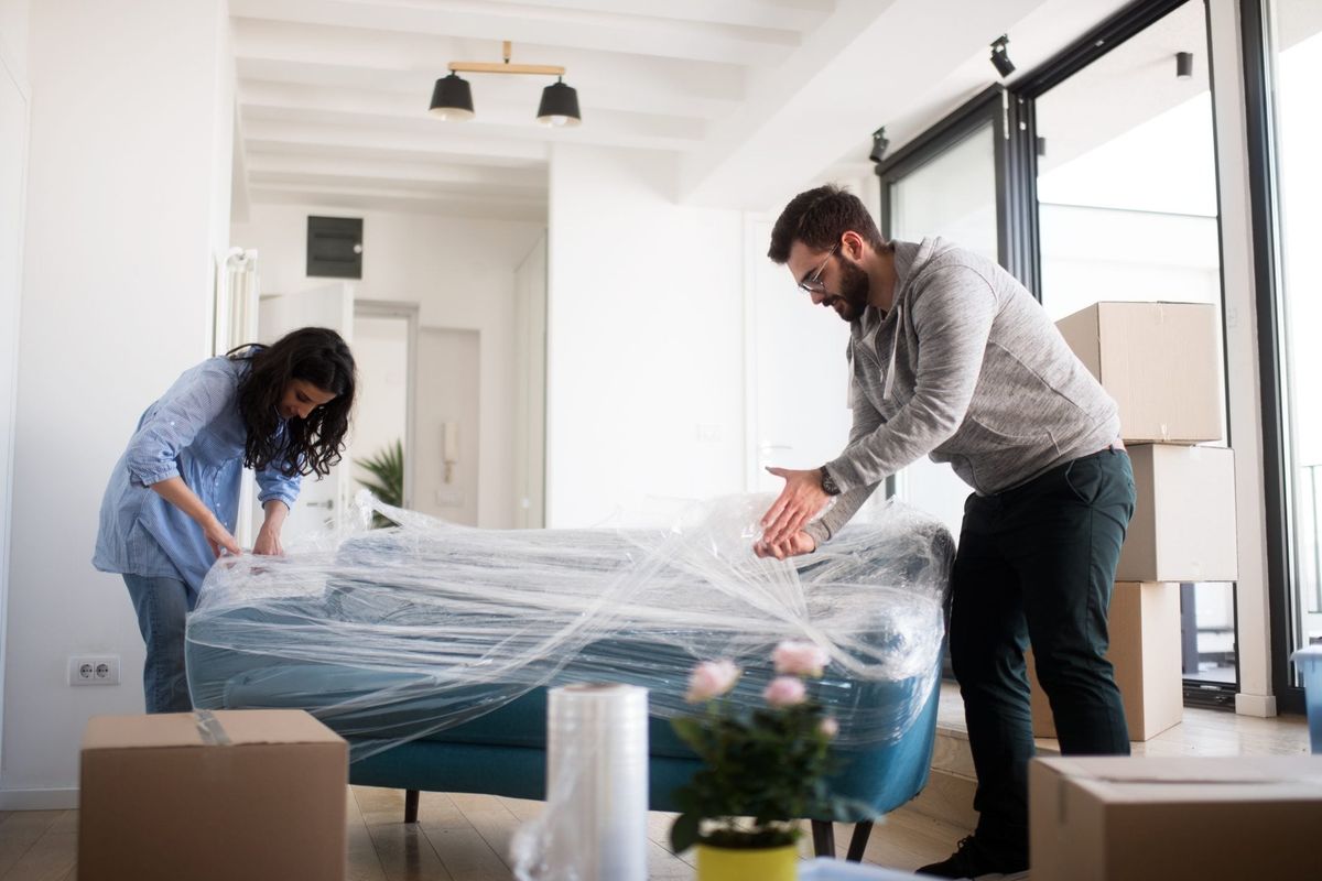 Handyman assembling and installing furniture in a modern living room